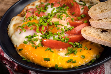 Homemade breakfast fried egg with tomato.