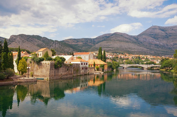 Beautiful landscape with an ancient city on the river bank.  Bosnia and Herzegovina, view of Trebisnjica river and Old Town of Trebinje