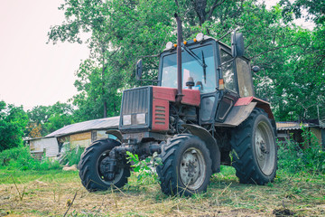 Obraz premium Tractor for working in the field and mowing grass