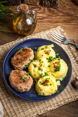 Meatballs served with boiled potatoes.