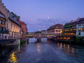 Sunset along the Ill River in Petite France areas of Strasbourg in the Alsace region of France. The homes are the traditional half timbered houses visible all over this area of France.