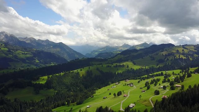 Drone flight through Swiss Alps and Lush Green Valley
