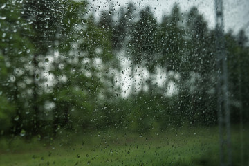 Drops on the glass on the train. On a long trip heavy rain