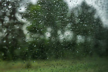Drops on the glass on the train. On a long trip heavy rain