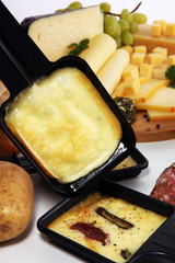 Delicious traditional Swiss melted raclette cheese on diced boiled or baked potato.
