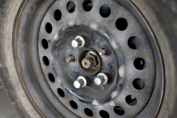 old rusty car wheel disk with unscrewed bolts. replacement of a car tire. tire fitting