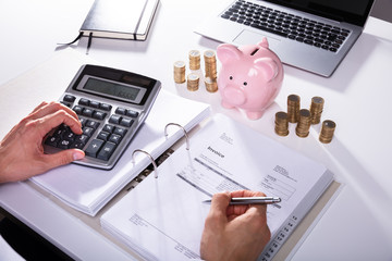Businessman Calculating Invoice