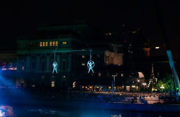 Suspended acrobats in blue light