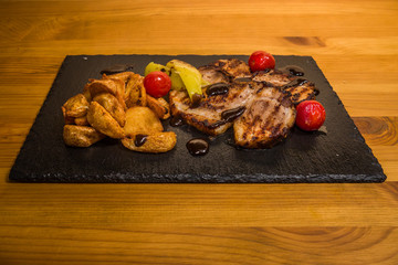 Delicious meat with vegetables, cooked on the grill. Fresh and juicy food