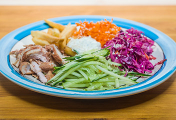 Delicious salad of fresh vegetables with spices on a plate. European Cafe