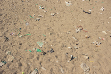 result of human activity pollution concept of many garbage objects on dirty sand with empty space for copy or text