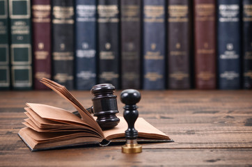 Notary Seal, Judge Gavel and Law book on a wooden background. - obrazy, fototapety, plakaty
