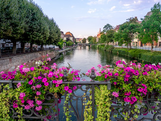 Fototapeta na wymiar Along the Ill River in Petite France areas of Strasbourg in the Alsace region of France. The homes are the traditional half timbered houses visible all over this area of France.