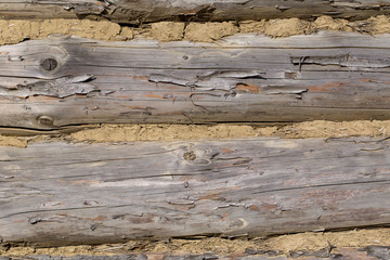 Naklejka premium Old wooden home wall background, log house with clay seal close up