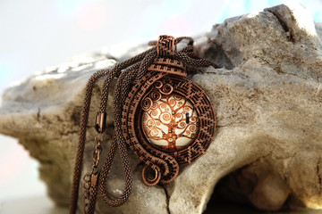 Vintage copper jewelry necklace on stone background, hand made