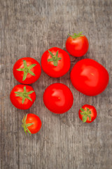 Cherry tomatoes on a wooden background. Autumn harvesting.