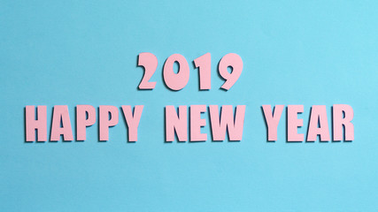 Inscription with the New Year 2019 on a turquoise textured background, top view
