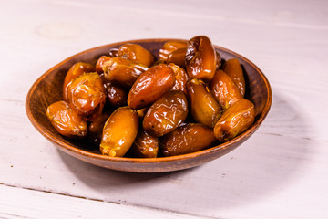 Date fruits on the white wooden table