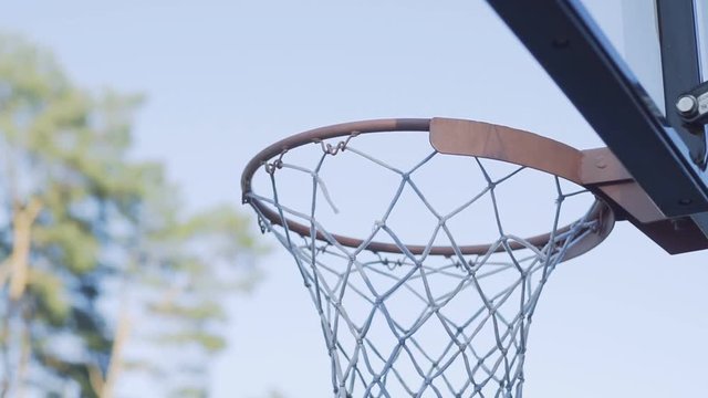Close up of a basketball player dunking the ball