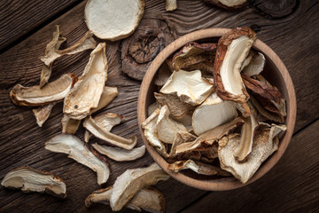 Dried mushrooms in wooden bowl.