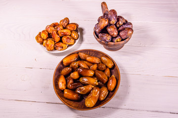 Date fruits on the white wooden table