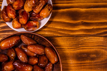 Date fruits on a wooden table. Top view