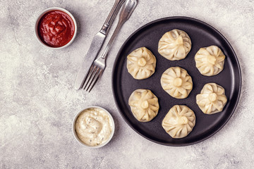 Traditional steamed dumplings Khinkali with Tomato and Tartar sauce