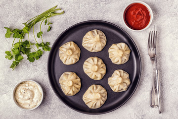 Traditional steamed dumplings Khinkali with Tomato and Tartar sauce