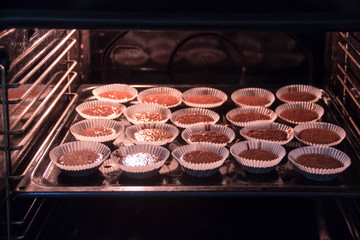 Chocolate muffins are baked in the oven