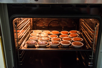 Chocolate muffins are baked in the oven