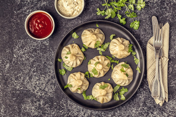 Traditional steamed dumplings Khinkali with Tomato and Tartar sauce