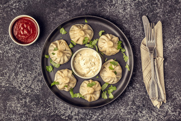 Traditional steamed dumplings Khinkali with Tomato and Tartar sauce