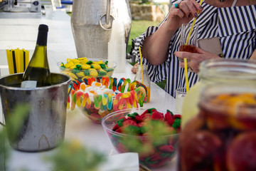Multicolored jelly candies on a bar counter in vases