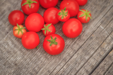 Cherry tomatoes on a wooden background. Autumn harvesting.