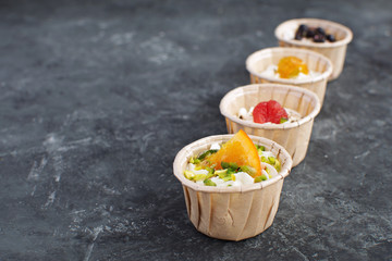 Gourmet food Snack Tartlet Creamy goat cheese Dried Fruit Appetizer Dark concrete background Copy space French cuisine