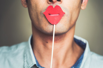 close up of a man's chin wearing a fake paper made red lips