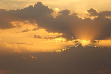 Beautiful sunset with clouds of orange and yellow in the ocean, the river