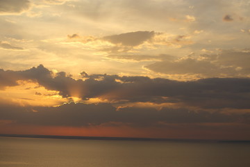 Beautiful sunset with clouds of orange and yellow in the ocean, the river