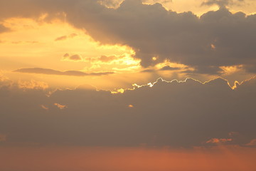 Beautiful sunset with clouds of orange and yellow in the ocean, the river