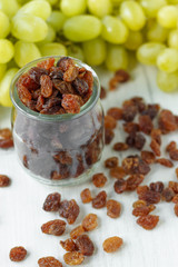 a bunch of grapes raisins on a white background