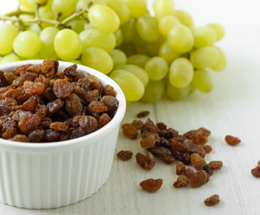 a bunch of grapes raisins on a white background