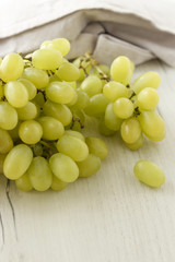 a bunch of grapes on a wooden background