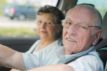 elderly couple in the car
