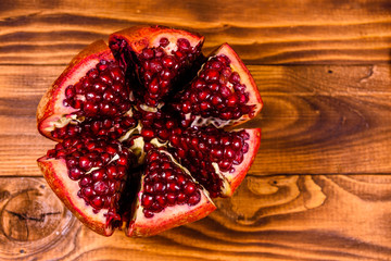 Sliced ripe garnet fruit on wooden table. Top view