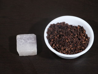 Clove alum and Mustard Oil on Wooden Background, Clove and Mustard oil in White Bowl,Clove Powder,Whole Clove in White Bowl,
