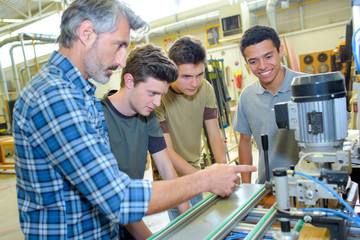 engineers and apprentices with cnc machine