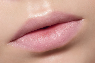 Fototapeta premium Perfect natural lip makeup. Close up macro photo with beautiful female mouth. Plump full lips. Close-up face detail. Perfect clean skin, light fresh lip make-up. Beautiful spa tender lip