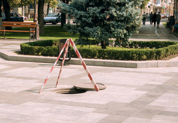 An outdoor fencing hatch for the safety of passers-by in the park in the summer