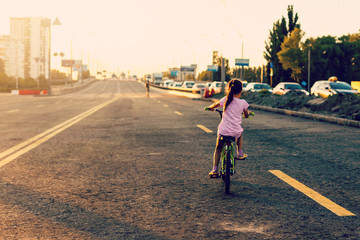 little girl learning ride a bicycle. Spring/summer/autumn active sport leisure for kids. kid on bike