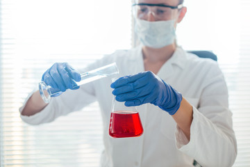 Laboratory work, technician with erlenmeyer flask